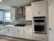 Kitchen area featuring white cabinets, stainless steel appliances, and tile backsplash at 1249 Crested Iris Way, North Myrtle Beach, SC 29582