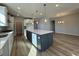 Open concept kitchen with quartz countertops, a large island, and stainless steel appliances at 1249 Crested Iris Way, North Myrtle Beach, SC 29582