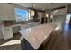 Bright kitchen with white cabinets, a large island, stainless steel appliances, and a window overlooking the yard at 1249 Crested Iris Way, North Myrtle Beach, SC 29582