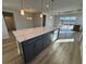 Modern kitchen with a large island, stainless steel appliances, and hardwood floors at 1249 Crested Iris Way, North Myrtle Beach, SC 29582