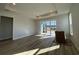 Spacious living room with hardwood floors and sliding glass doors leading to the patio at 1249 Crested Iris Way, North Myrtle Beach, SC 29582
