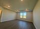 A spacious main bedroom with recessed lighting, hardwood floors and bright double windows at 1249 Crested Iris Way, North Myrtle Beach, SC 29582