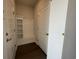 Mud room with coat rack and storage shelves next to doors and dark vinyl flooring at 1249 Crested Iris Way, North Myrtle Beach, SC 29582
