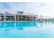 Resort-style pool with plenty of seating, umbrellas and palm trees at 1249 Crested Iris Way, North Myrtle Beach, SC 29582