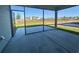 A roomy screened porch has a concrete floor and overlooks a grass lawn at 1249 Crested Iris Way, North Myrtle Beach, SC 29582