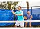 Active couple playing tennis on a well-maintained court, enjoying an active outdoor lifestyle at 1249 Crested Iris Way, North Myrtle Beach, SC 29582