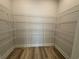 Spacious walk-in closet with wire shelving and hardwood floors at 1249 Crested Iris Way, North Myrtle Beach, SC 29582