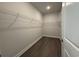 Walk-in closet featuring wood floors and white wire shelving for ample storage space at 1249 Crested Iris Way, North Myrtle Beach, SC 29582