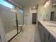 Bathroom featuring a glass enclosed shower, double sink vanity, and modern fixtures at 1253 Crested Iris Way, North Myrtle Beach, SC 29582