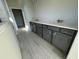 Stylish bathroom with double vanity, sleek gray cabinets, and tile flooring at 1253 Crested Iris Way, North Myrtle Beach, SC 29582