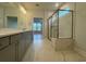 Bathroom featuring double sinks with quartz countertops, and walk-in shower at 1253 Crested Iris Way, North Myrtle Beach, SC 29582