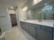 Bathroom featuring double sinks with quartz countertops, and walk-in shower at 1253 Crested Iris Way, North Myrtle Beach, SC 29582