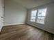 Bright bedroom with hardwood floors and a double window view at 1253 Crested Iris Way, North Myrtle Beach, SC 29582