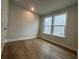Cozy bedroom with hardwood floors and a large window at 1253 Crested Iris Way, North Myrtle Beach, SC 29582