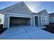 Spacious two-car garage with concrete flooring on a house with gray siding at 1253 Crested Iris Way, North Myrtle Beach, SC 29582