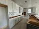 Spacious kitchen featuring white cabinets, island, and abundant natural light at 1253 Crested Iris Way, North Myrtle Beach, SC 29582