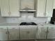 Modern kitchen featuring white cabinets, stainless steel appliances, and stylish backsplash at 1253 Crested Iris Way, North Myrtle Beach, SC 29582