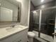 Bright bathroom featuring tiled shower with glass door at 1257 Crested Iris Way, North Myrtle Beach, SC 29582