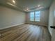 Bright bedroom with wood-look flooring and a large window at 1257 Crested Iris Way, North Myrtle Beach, SC 29582