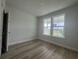 Bedroom with wood-look flooring, natural light, and large window at 1257 Crested Iris Way, North Myrtle Beach, SC 29582