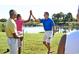 Group celebrating a great shot on the golf course, showcasing community spirit at 1257 Crested Iris Way, North Myrtle Beach, SC 29582