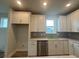 Gourmet kitchen featuring a stainless steel dishwasher, custom cabinets, and sleek countertops at 1257 Crested Iris Way, North Myrtle Beach, SC 29582