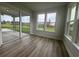 Relaxing sunroom with sliding glass doors, light vinyl plank flooring and views of the home's backyard at 1257 Crested Iris Way, North Myrtle Beach, SC 29582