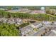 An aerial view of a quiet community surrounded by green trees, a pond, and a water tower in the background at 1298 Harvester Circle # 1298, Myrtle Beach, SC 29579