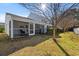 Exterior of a home with a screened in porch, mature trees, and bushes at 1298 Harvester Circle # 1298, Myrtle Beach, SC 29579