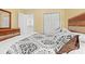 Bedroom with tan walls, closet, dark wooden furniture, and comfortable bedding at 1298 Harvester Circle # 1298, Myrtle Beach, SC 29579
