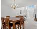 Open concept dining area showcases a wooden table set for four, with views of the living room at 1298 Harvester Circle # 1298, Myrtle Beach, SC 29579
