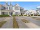 Well-maintained townhouses featuring neutral siding, dark shutters, and manicured landscaping at 1298 Harvester Circle # 1298, Myrtle Beach, SC 29579