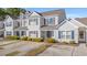 Charming two-story townhouse featuring neutral siding, black shutters, and manicured landscaping at 1298 Harvester Circle # 1298, Myrtle Beach, SC 29579