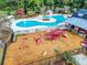 A high-angle shot showcases a red playground and nearby community pool surrounded by trees at 1298 Harvester Circle # 1298, Myrtle Beach, SC 29579
