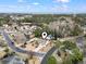 Aerial view showcases a home nestled in a lush neighborhood with the ocean in the distance at 14 Cobblestone Dr., Pawleys Island, SC 29585