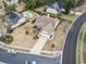 Aerial view of a home with manicured lawn, driveway, and lush surrounding landscape in a lovely neighborhood at 14 Cobblestone Dr., Pawleys Island, SC 29585