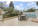 Outdoor patio with dining table and chairs, landscaping, and privacy fence at 14 Cobblestone Dr., Pawleys Island, SC 29585