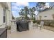 Outdoor patio with grill, seating, and landscaped yard at 14 Cobblestone Dr., Pawleys Island, SC 29585