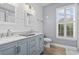 Bright bathroom with double vanity, shiplap walls, and decorative coastal accents at 14 Cobblestone Dr., Pawleys Island, SC 29585