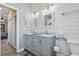 Stylish bathroom with dual sinks, modern lighting, and shiplap wall design at 14 Cobblestone Dr., Pawleys Island, SC 29585