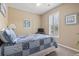 Cozy bedroom featuring a ceiling fan, window with shutters, and a beautiful quilt on the bed at 14 Cobblestone Dr., Pawleys Island, SC 29585