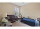 Bright bedroom with a crib, twin bed, rocking chair, and window with shutters at 14 Cobblestone Dr., Pawleys Island, SC 29585