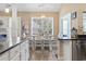 Bright dining area features a white table and chairs and plantation shutters allowing for natural light at 14 Cobblestone Dr., Pawleys Island, SC 29585