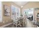 Dining area with table, chairs, and bright window with plantation shutters that allows natural light in at 14 Cobblestone Dr., Pawleys Island, SC 29585