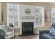 Close up on the fireplace with decorative mantle, white shutters, and a coastal clock at 14 Cobblestone Dr., Pawleys Island, SC 29585
