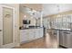 Open concept kitchen boasts stainless appliances, granite counters and white cabinetry with views to the living and dining areas at 14 Cobblestone Dr., Pawleys Island, SC 29585