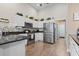 Bright kitchen features white cabinets, stainless steel appliances, granite countertops, and decorative tile backsplash at 14 Cobblestone Dr., Pawleys Island, SC 29585