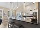 Open concept kitchen with stainless appliances, granite counters, bar stool seating and views of the dining and living areas at 14 Cobblestone Dr., Pawleys Island, SC 29585