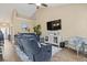 Comfortable living room featuring blue furniture, a ceiling fan, and a wall-mounted TV at 14 Cobblestone Dr., Pawleys Island, SC 29585