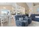 Open-concept living room with blue furniture, wood floors, and a glimpse of the modern kitchen at 14 Cobblestone Dr., Pawleys Island, SC 29585